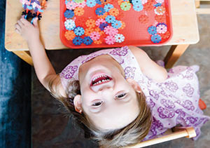 A little girl enjoys her summer camp at home.