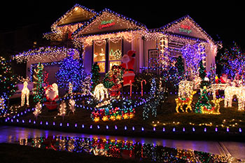 Christmas decorations light up a home at night."