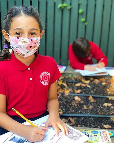 Charleston Day School students do schoolwork with masks so commonly seen during COVID-19.