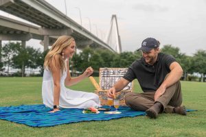 A couple picnicking near the Arthur Ravenel Bridge.