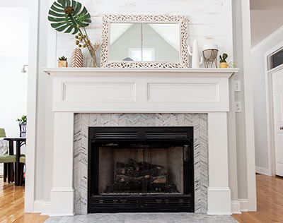 Update your fireplace with a unique mosaic backsplash, like this herringbone.