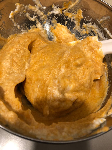 Ever so gently folding the egg whites into the pumpkin mixture