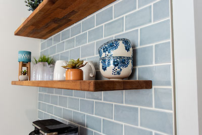 The beauty is in the details. This shelf holds small bowls, some cups and even a couple of plants.