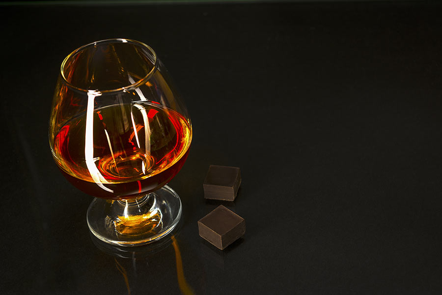 Chocolates with a glass of wine.