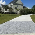 Morales Pavers: A new concrete driveway with a Herringbone Paver Entrance replaces an old cracked concrete driveway.
