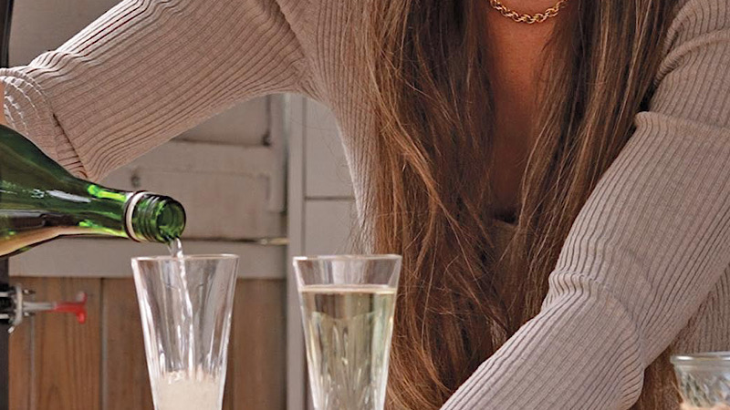 Photo of Brittany Olson pouring a glass of wine