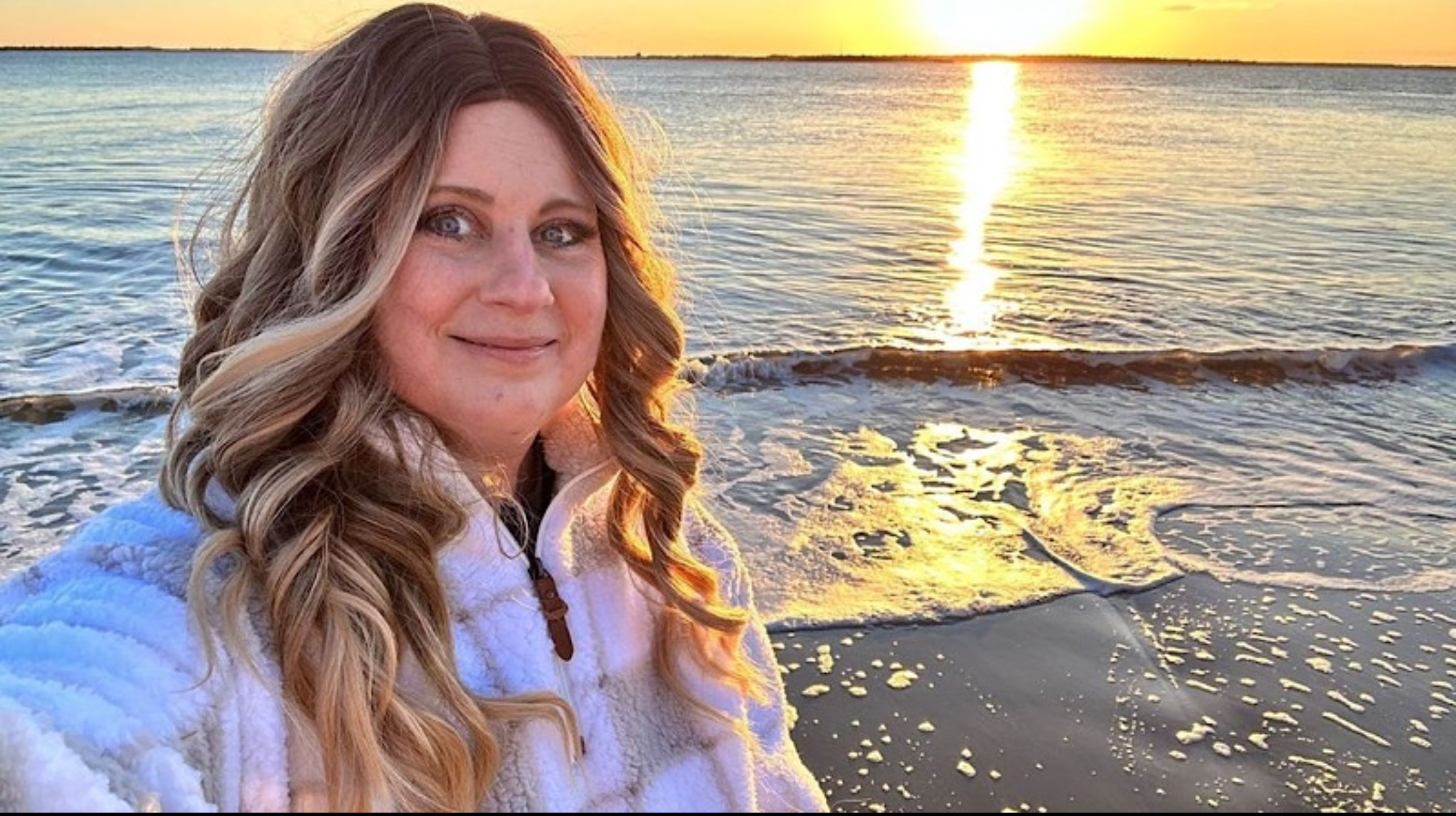 Melinda Morris in front of a beautiful sunset