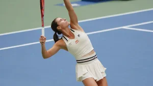 Emma Navarro looks up at the tennis ball as she prepares to serve