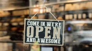 Sign on business door: Come in We're Open and Awesome