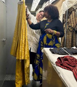 Curators examining vintage clothing