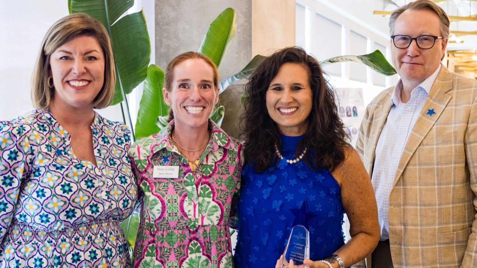 This image displays four people, who are honorees of the W.I.S.H. Society