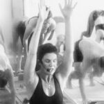 This image displays Sarah Frick a wellness instructor teaching a class yoga