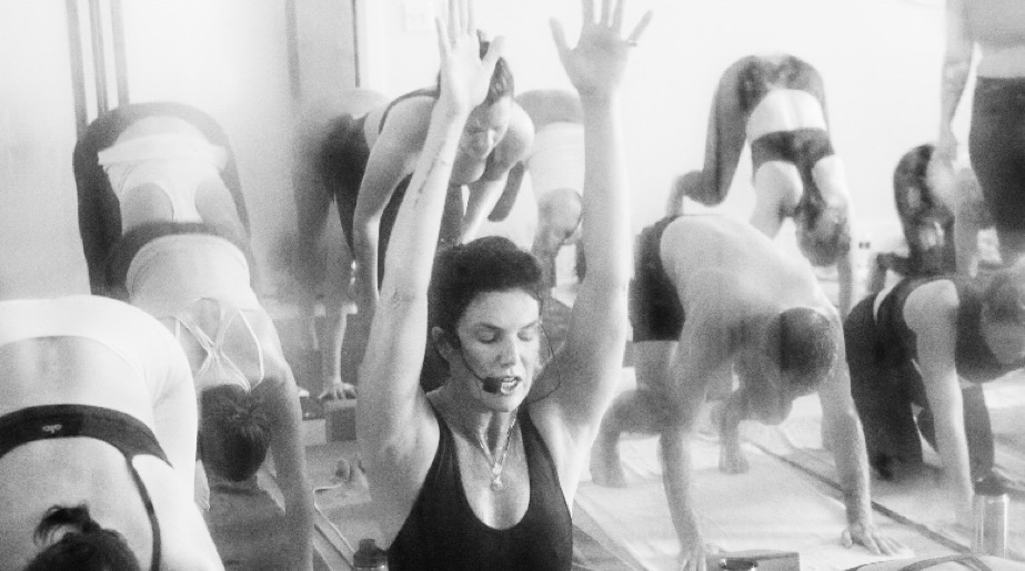 This image displays Sarah Frick a wellness instructor teaching a class yoga