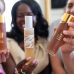 This image displays people holding up products created by “She Biology”