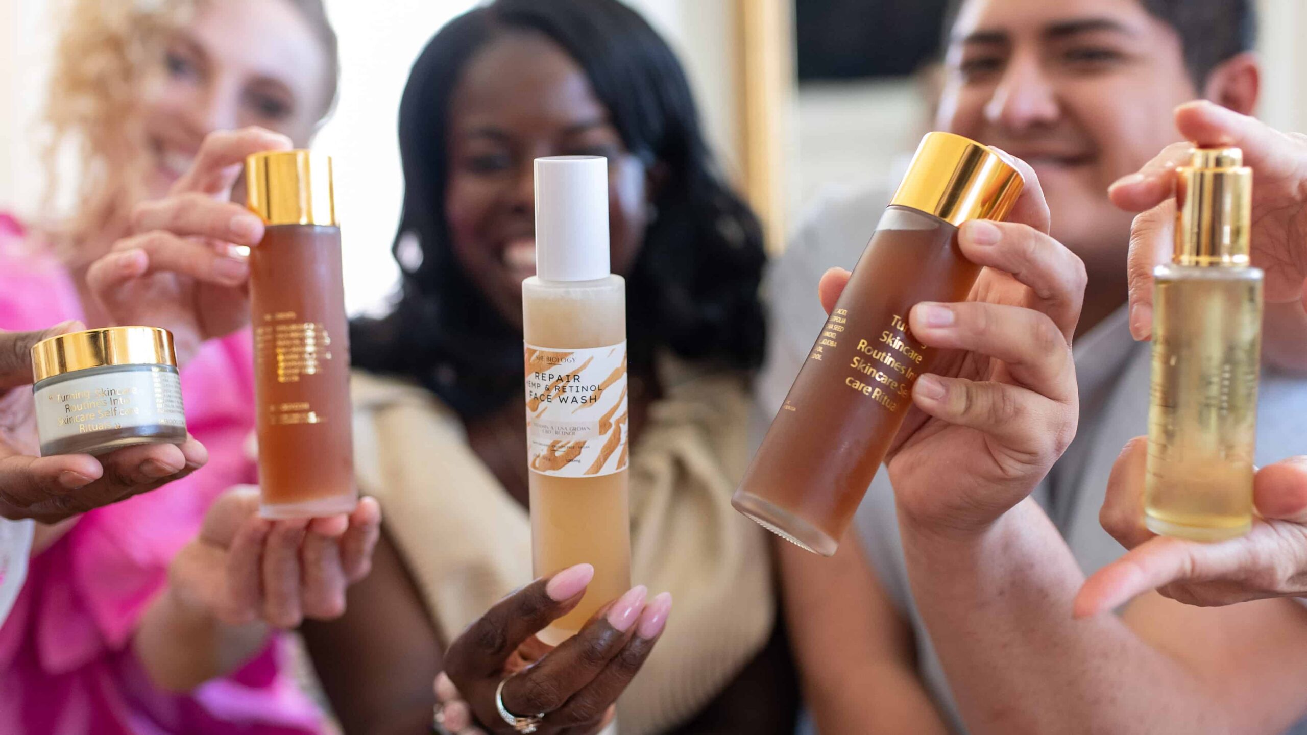 This image displays people holding up products created by “She Biology”