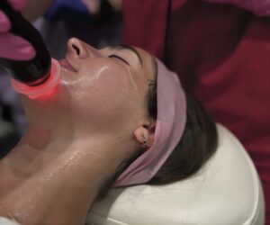 This image displays a woman getting a facial at “Soulshine Aesthetics”