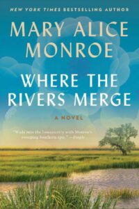 Book cover of Where the Rivers Merge by Mary Alice Monroe. The cover features a tranquil Lowcountry marsh landscape with tall green grasses, calm water, and a lone live oak tree beneath a soft blue sky. Large, translucent blue flowers overlay the upper portion of the cover behind the title. The author's name appears in gold lettering at the top, with the title in large white text. A quote from People magazine near the bottom reads, “Wade into the Lowcountry with Monroe’s sweeping Southern epic.”
